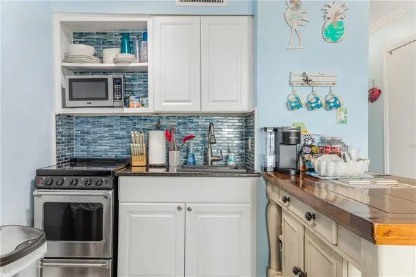 a kitchen with stainless steel appliances a stove and cabinets