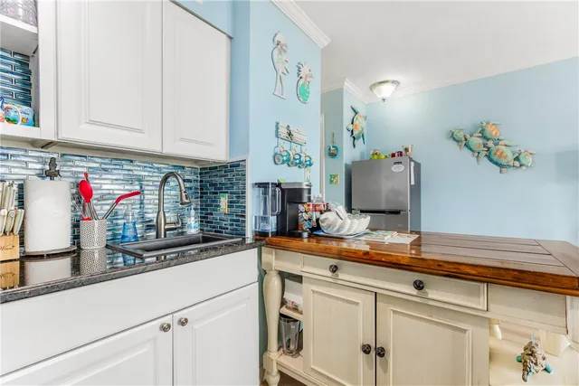 a kitchen with sink and cabinets