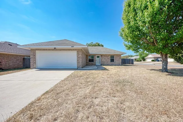 a front view of a house with a yard and a garage