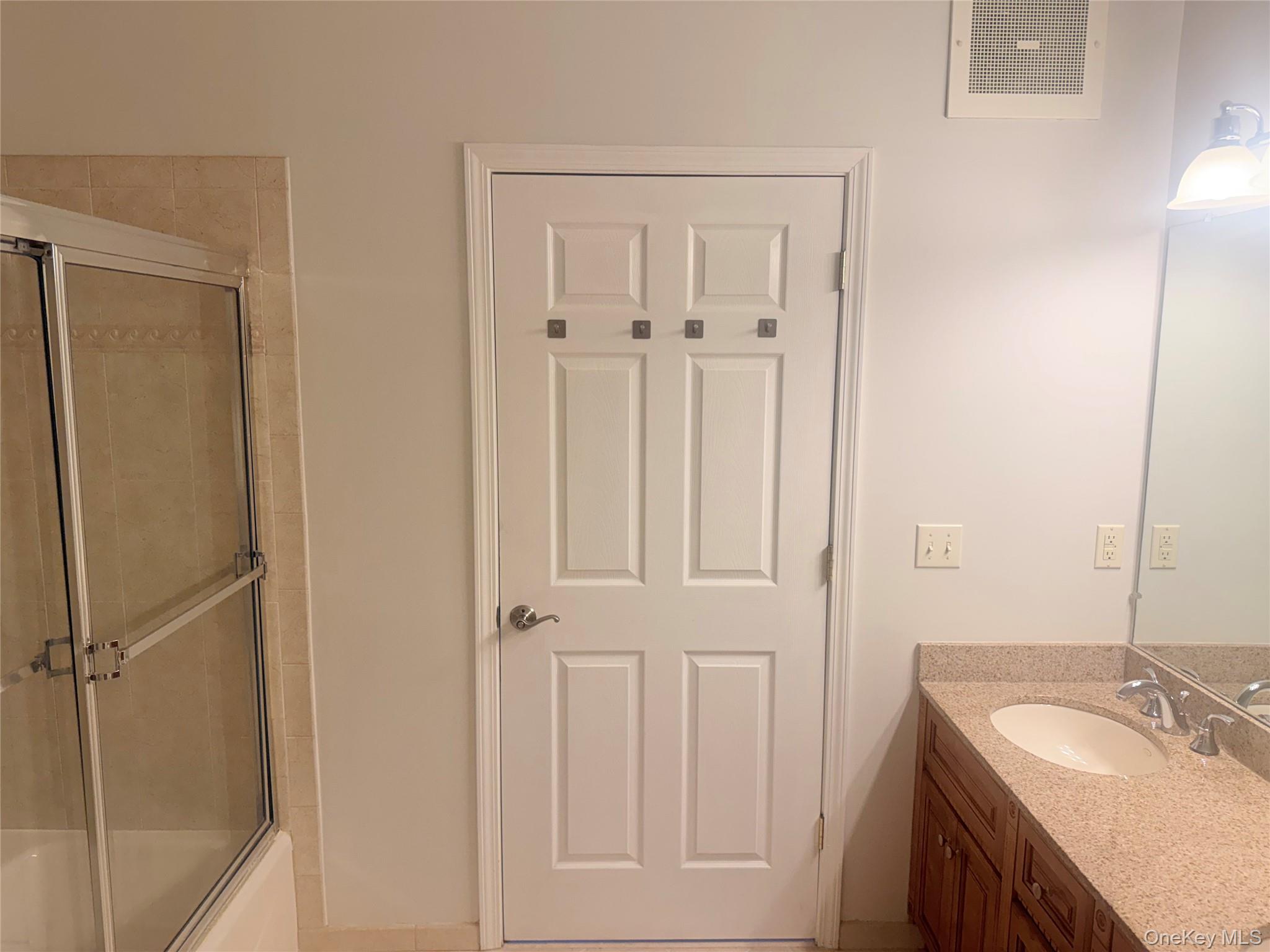 935 Tower Ridge Circle Middletown, NY 10941 - Photo 7 of 24 Bathroom vanity with a granite-style countertop, undermount sink, and dual-handle faucet