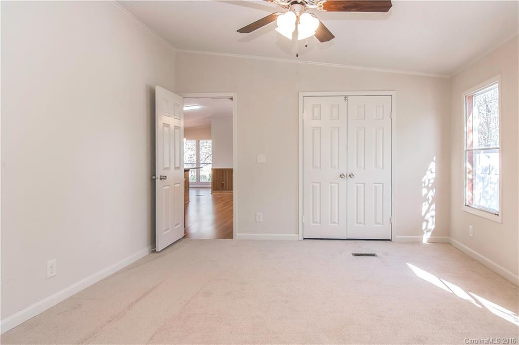 1815 Crowder Road Monroe, NC 28112 - Photo 14 of 24 an empty room with chandelier fan