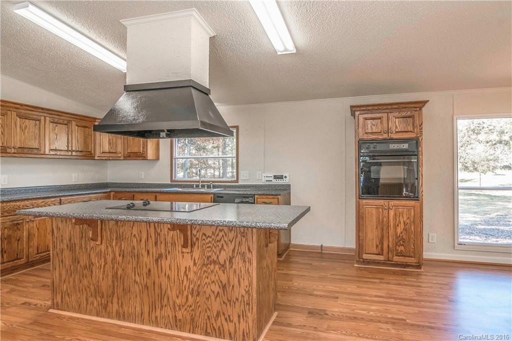 1815 Crowder Road Monroe, NC 28112 - Photo 3 of 24 a view of a kitchen with a stove wooden floor and a kitchen