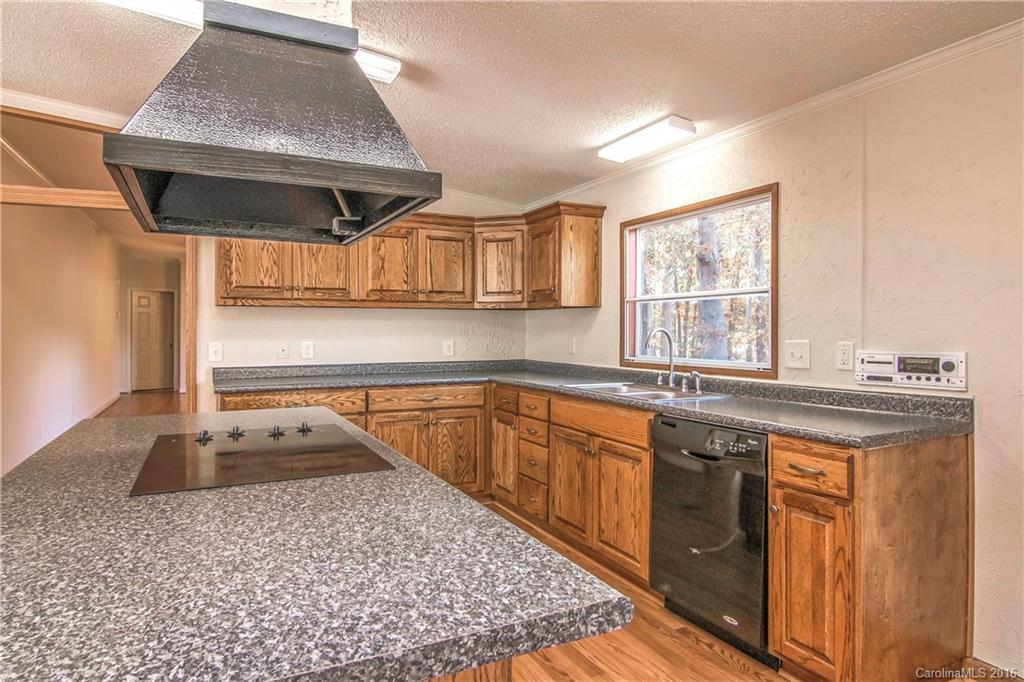 1815 Crowder Road Monroe, NC 28112 - Photo 5 of 24 a kitchen with a sink stove and cabinets
