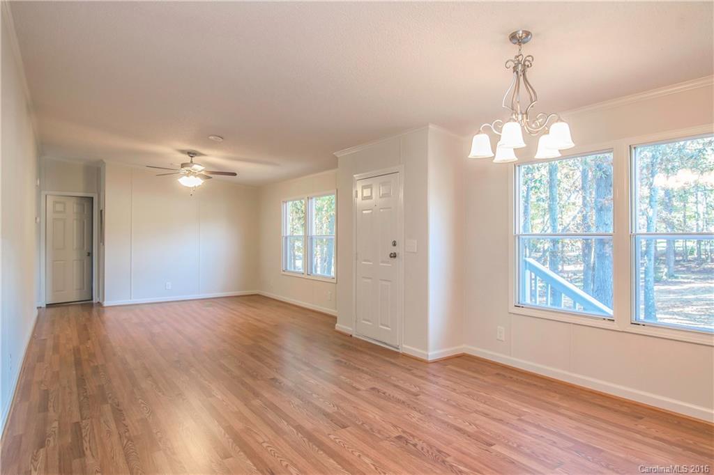 1815 Crowder Road Monroe, NC 28112 - Photo 9 of 24 a view of an empty room with wooden floor and a window