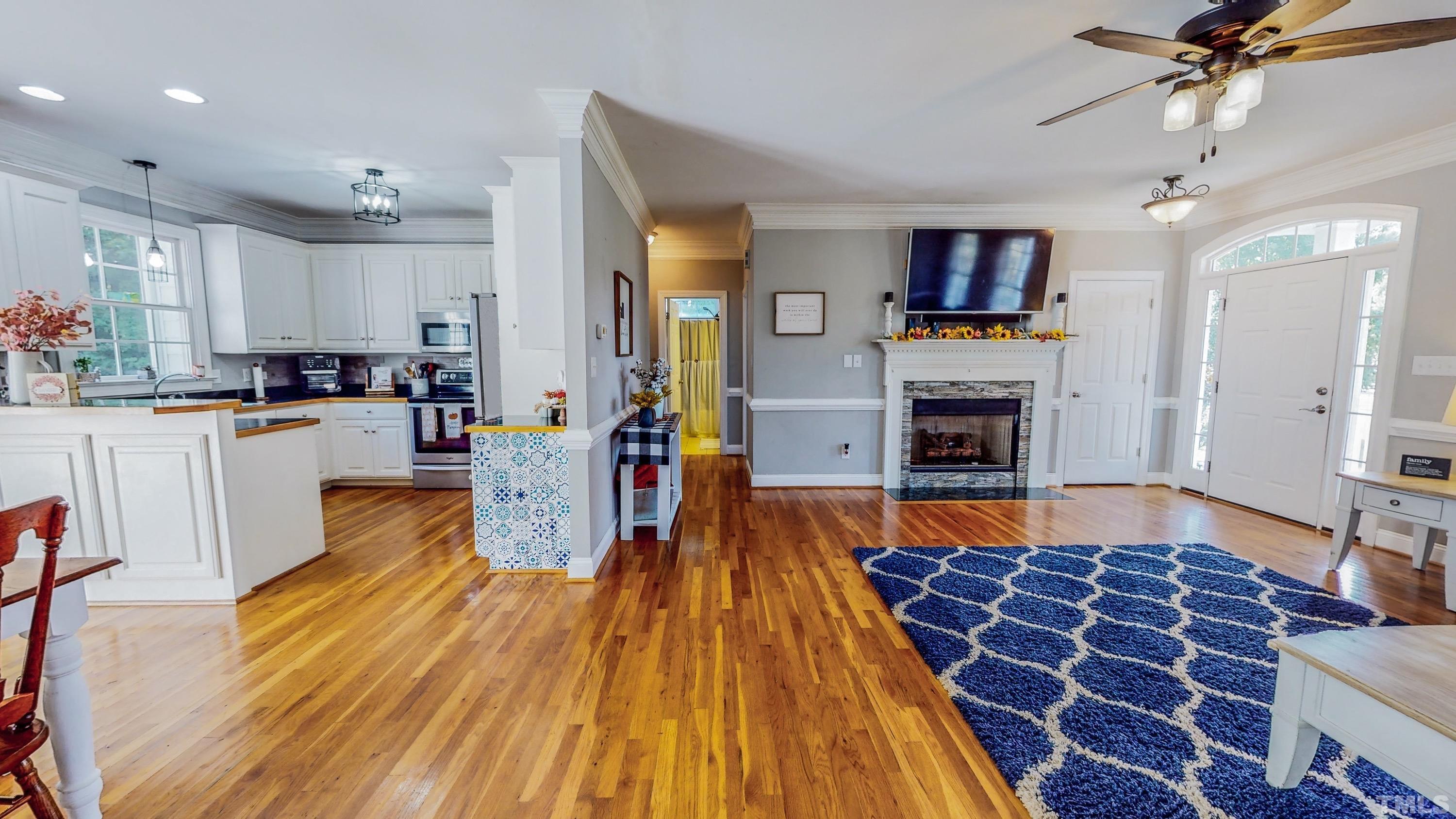 226 Fletcher Ridge Road Timberlake, NC 27583 - Photo 11 of 54 a living room with furniture and a wooden floor