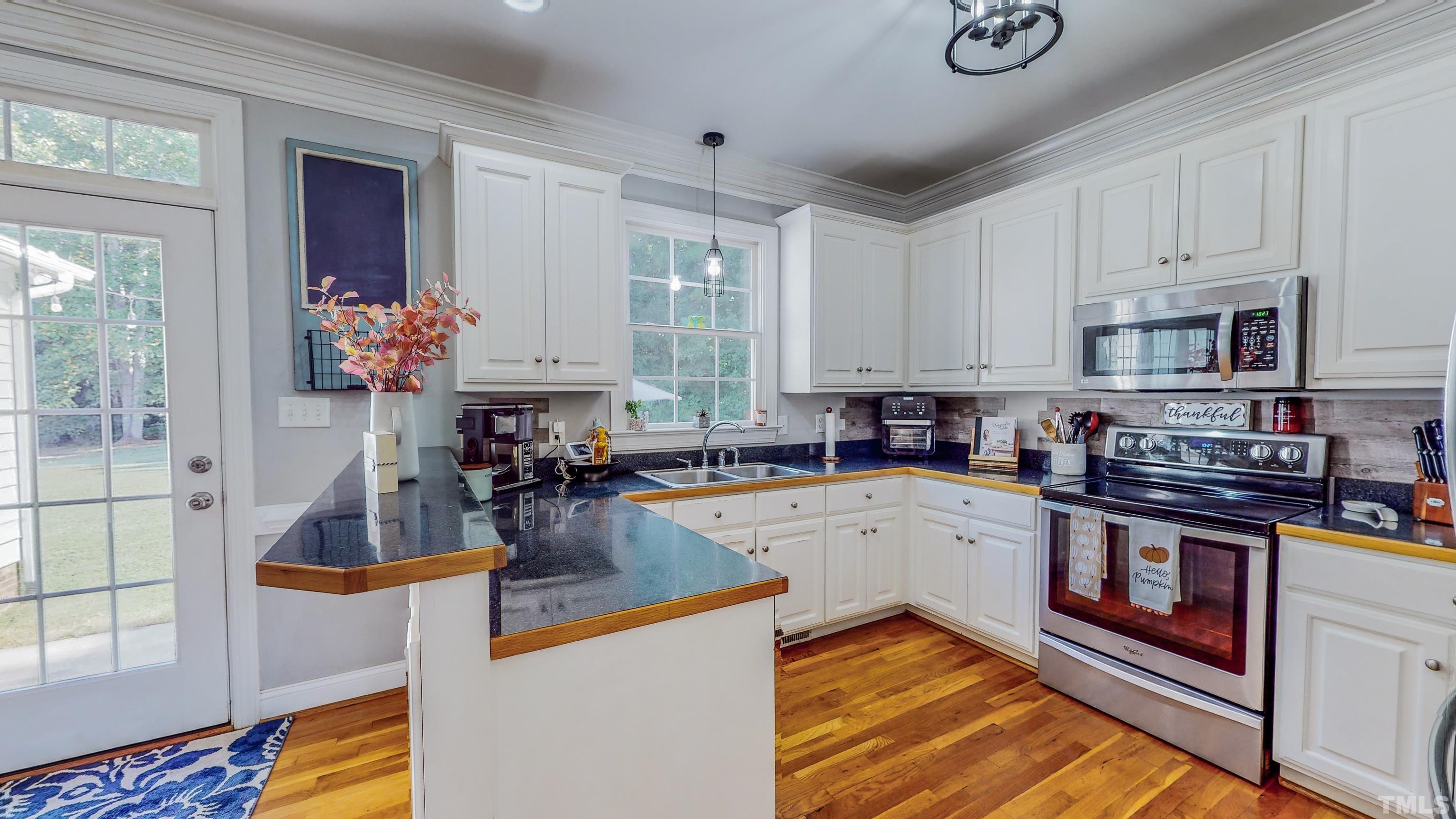 226 Fletcher Ridge Road Timberlake, NC 27583 - Photo 13 of 54 a kitchen with a stove a sink and a microwave