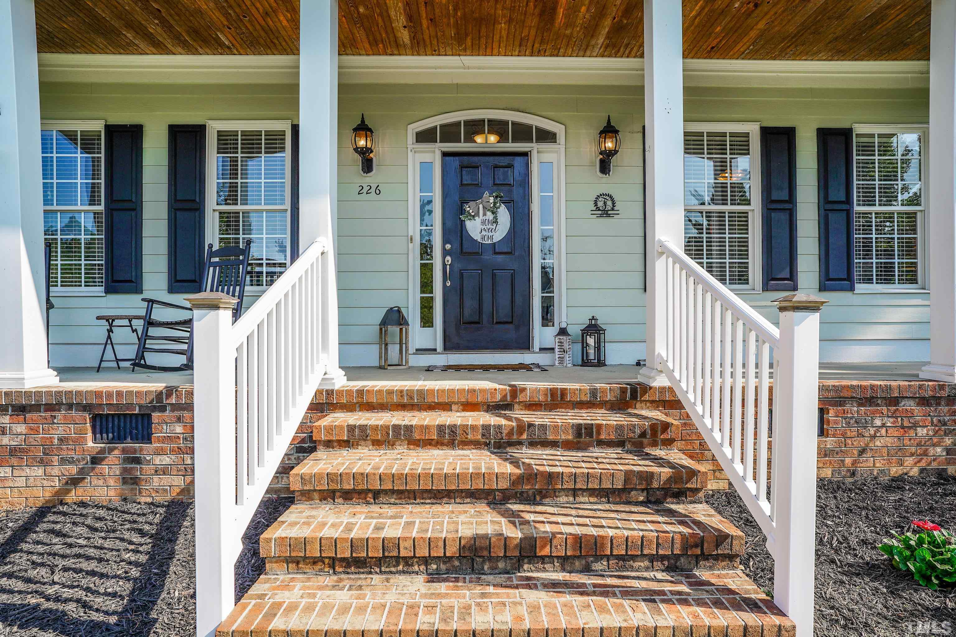 226 Fletcher Ridge Road Timberlake, NC 27583 - Photo 21 of 54 a front view of a house with a porch