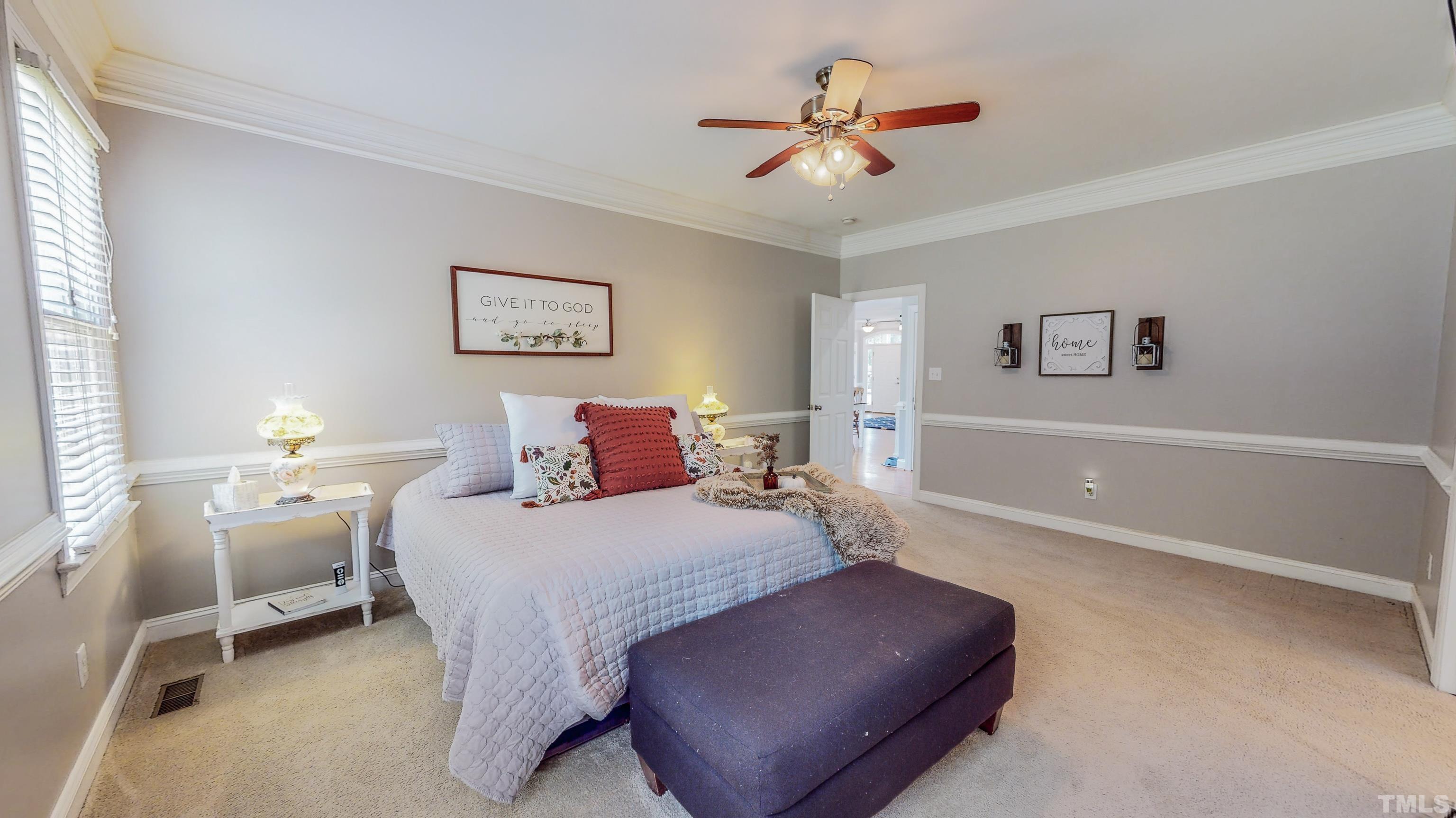 226 Fletcher Ridge Road Timberlake, NC 27583 - Photo 24 of 54 a bedroom with a bed and a chandelier