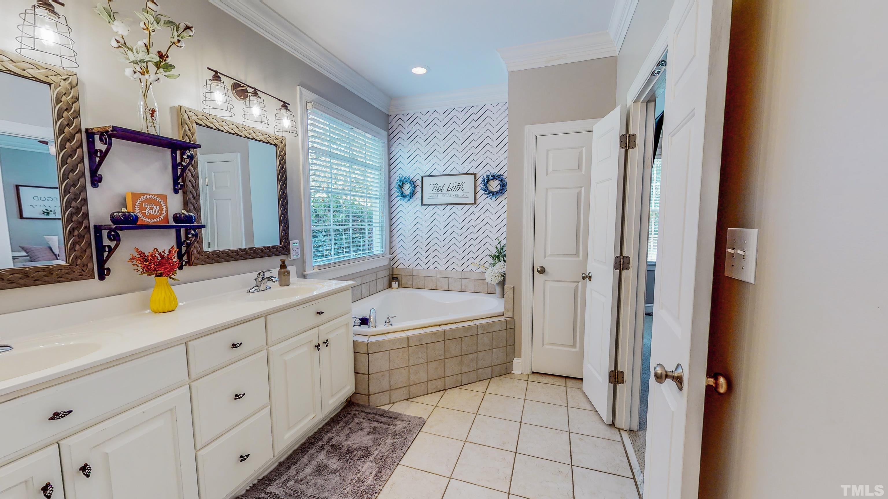 226 Fletcher Ridge Road Timberlake, NC 27583 - Photo 26 of 54 a spacious bathroom with a tub sink and mirror