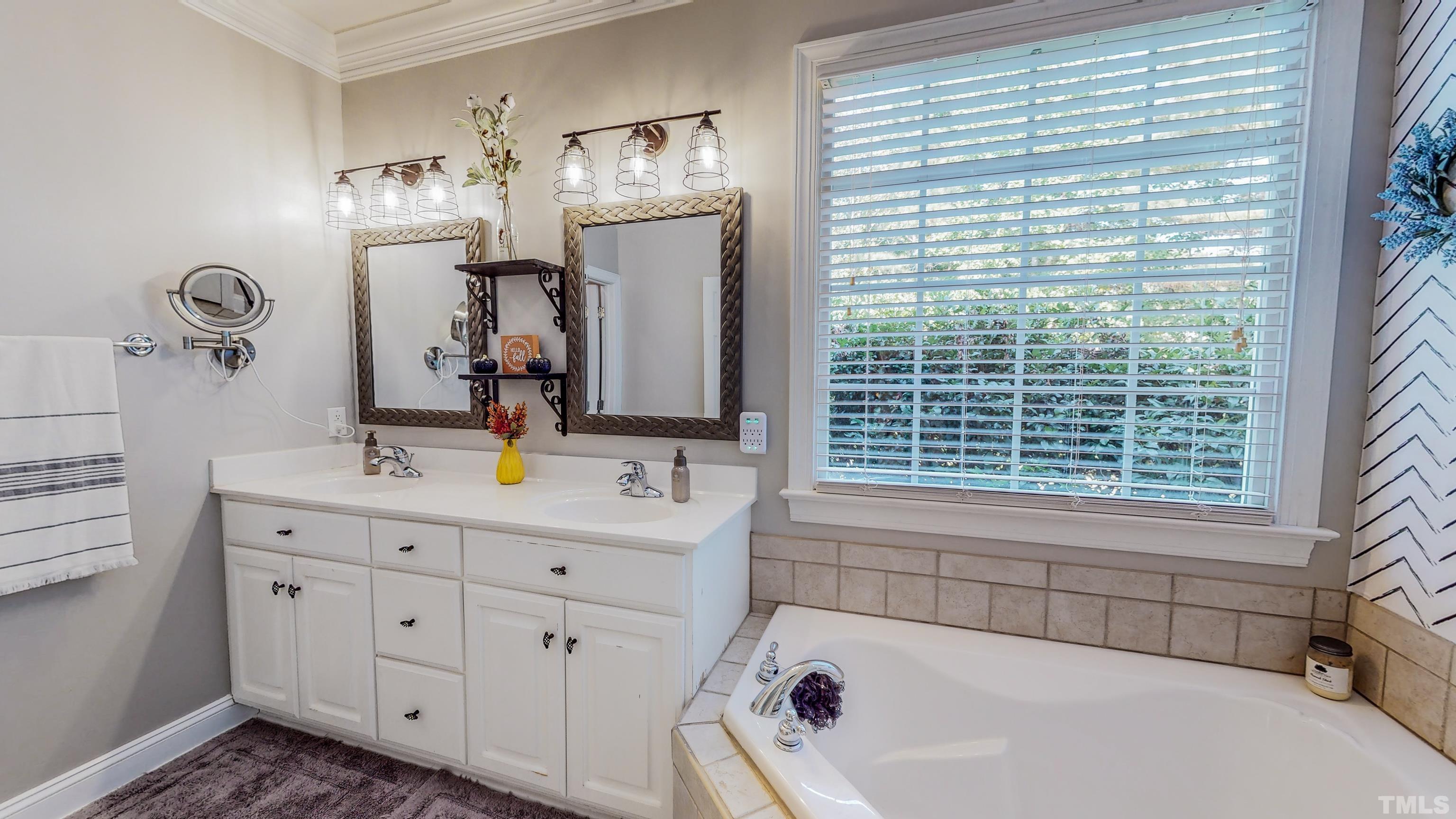 226 Fletcher Ridge Road Timberlake, NC 27583 - Photo 27 of 54 a bathroom with a tub sink and mirror