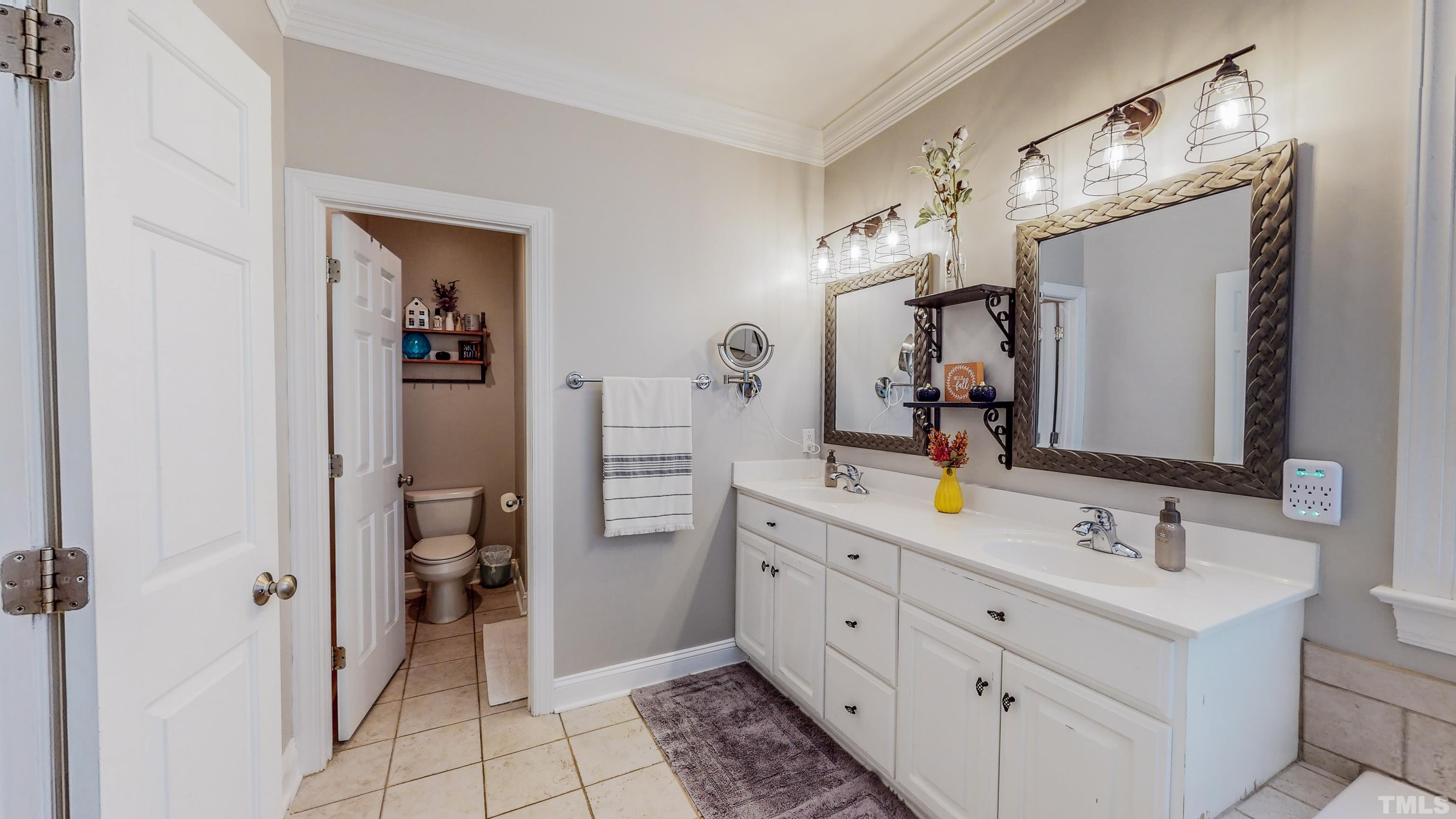 226 Fletcher Ridge Road Timberlake, NC 27583 - Photo 28 of 54 a bathroom with a double vanity sink mirror and toilet