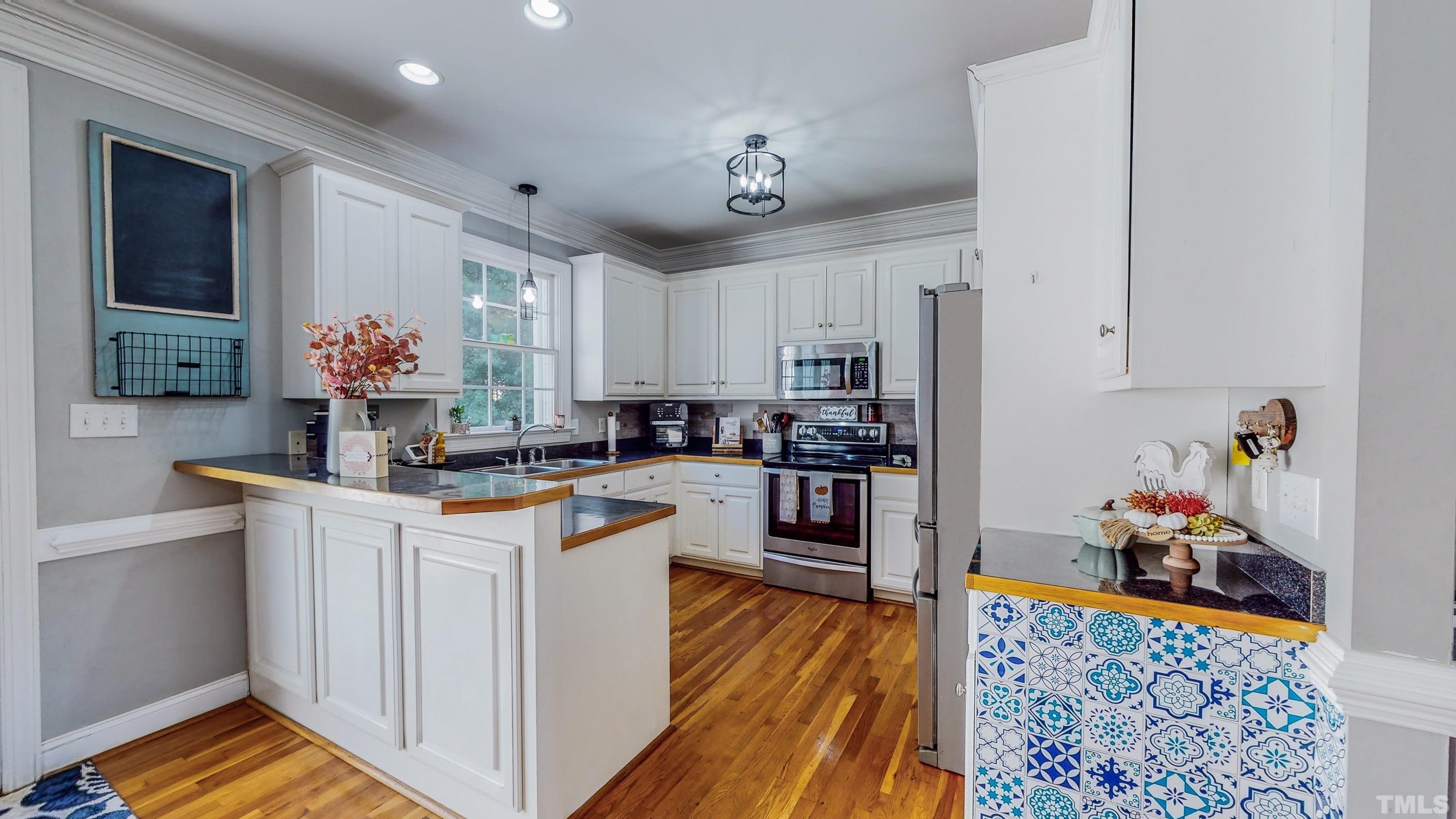 226 Fletcher Ridge Road Timberlake, NC 27583 - Photo 3 of 54 a kitchen with stainless steel appliances granite countertop a refrigerator and a stove top oven