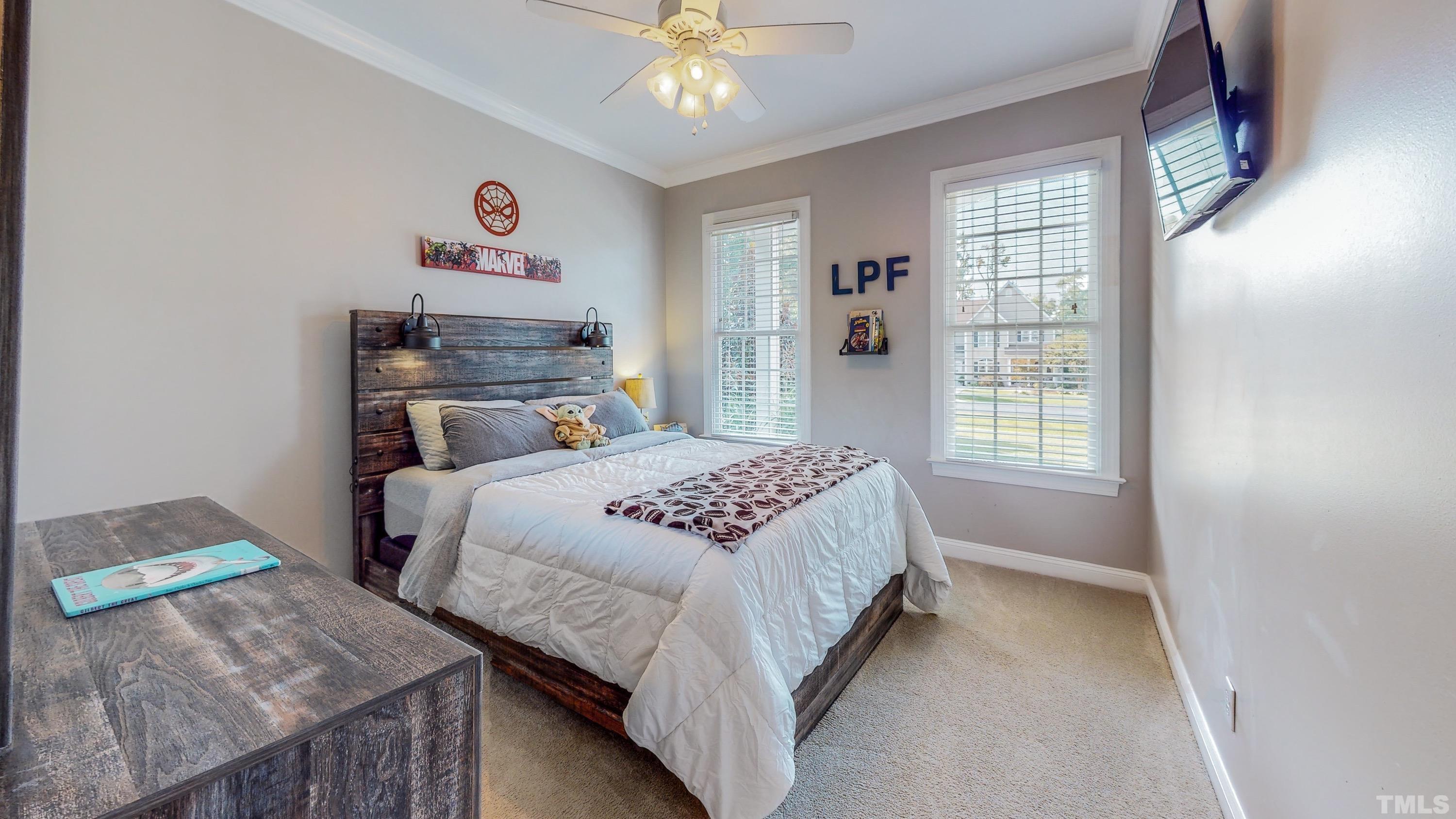 226 Fletcher Ridge Road Timberlake, NC 27583 - Photo 34 of 54 a bedroom with a bed and a chandelier