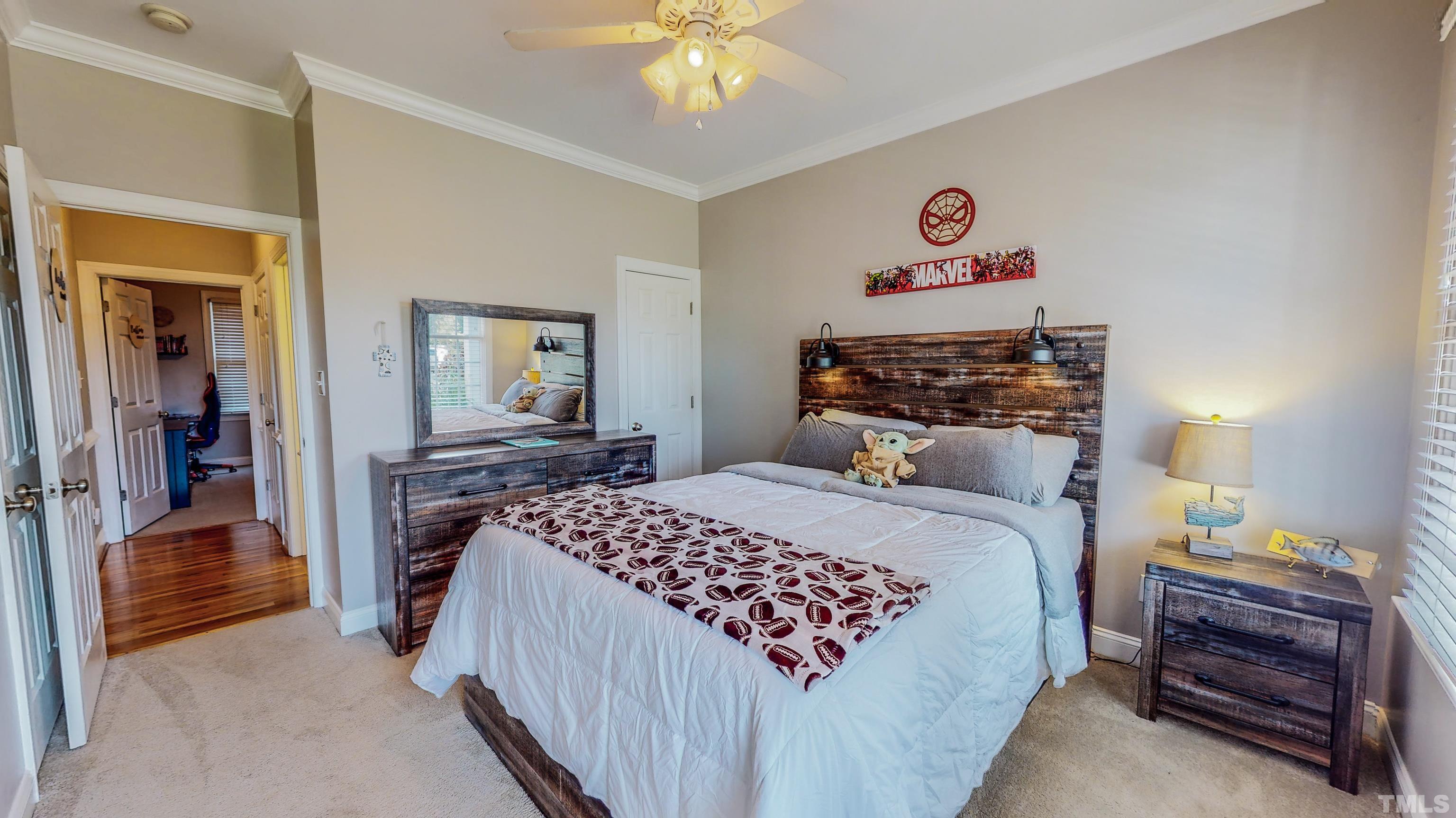 226 Fletcher Ridge Road Timberlake, NC 27583 - Photo 35 of 54 a bedroom with a bed and a chandelier