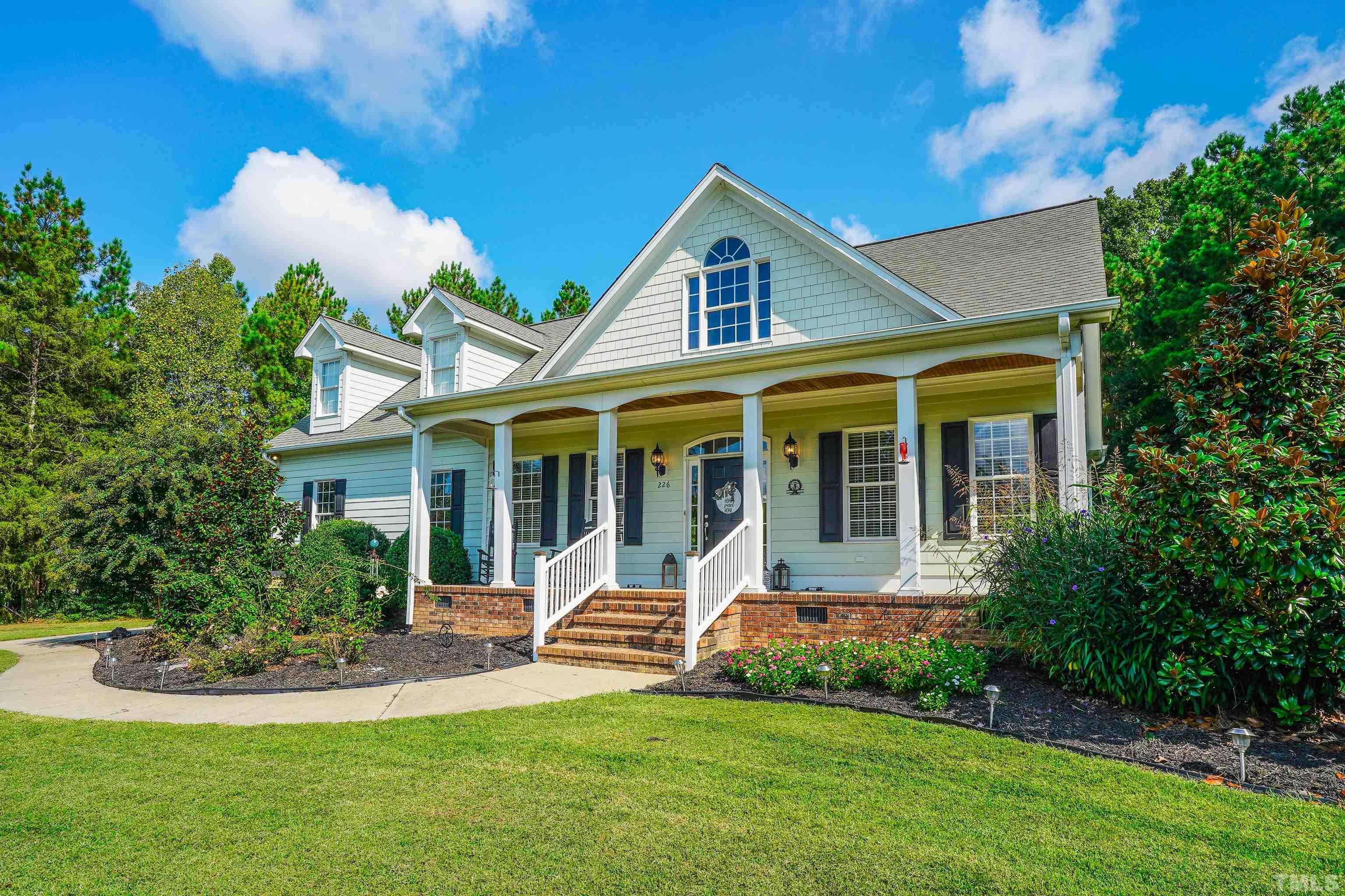 226 Fletcher Ridge Road Timberlake, NC 27583 - Photo 38 of 54 a view of a house with a yard and sitting area