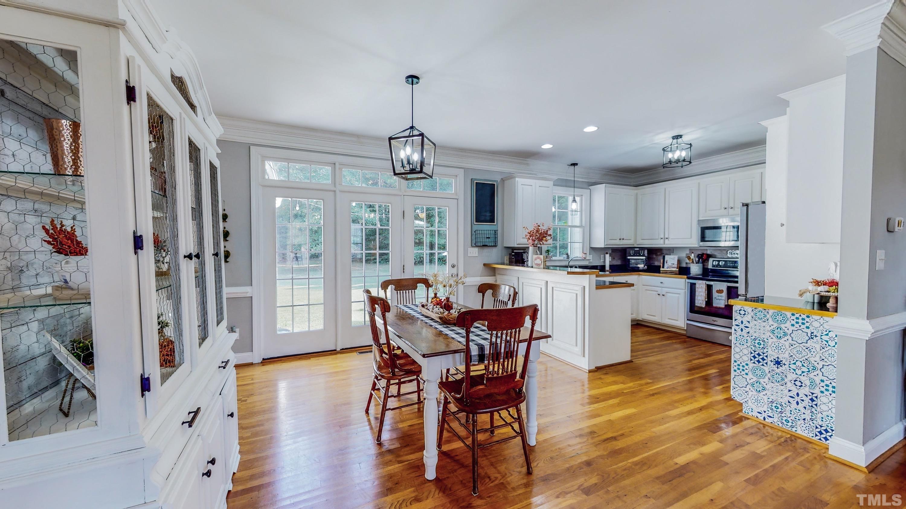 226 Fletcher Ridge Road Timberlake, NC 27583 - Photo 4 of 54 a living room with dining room and wooden floor