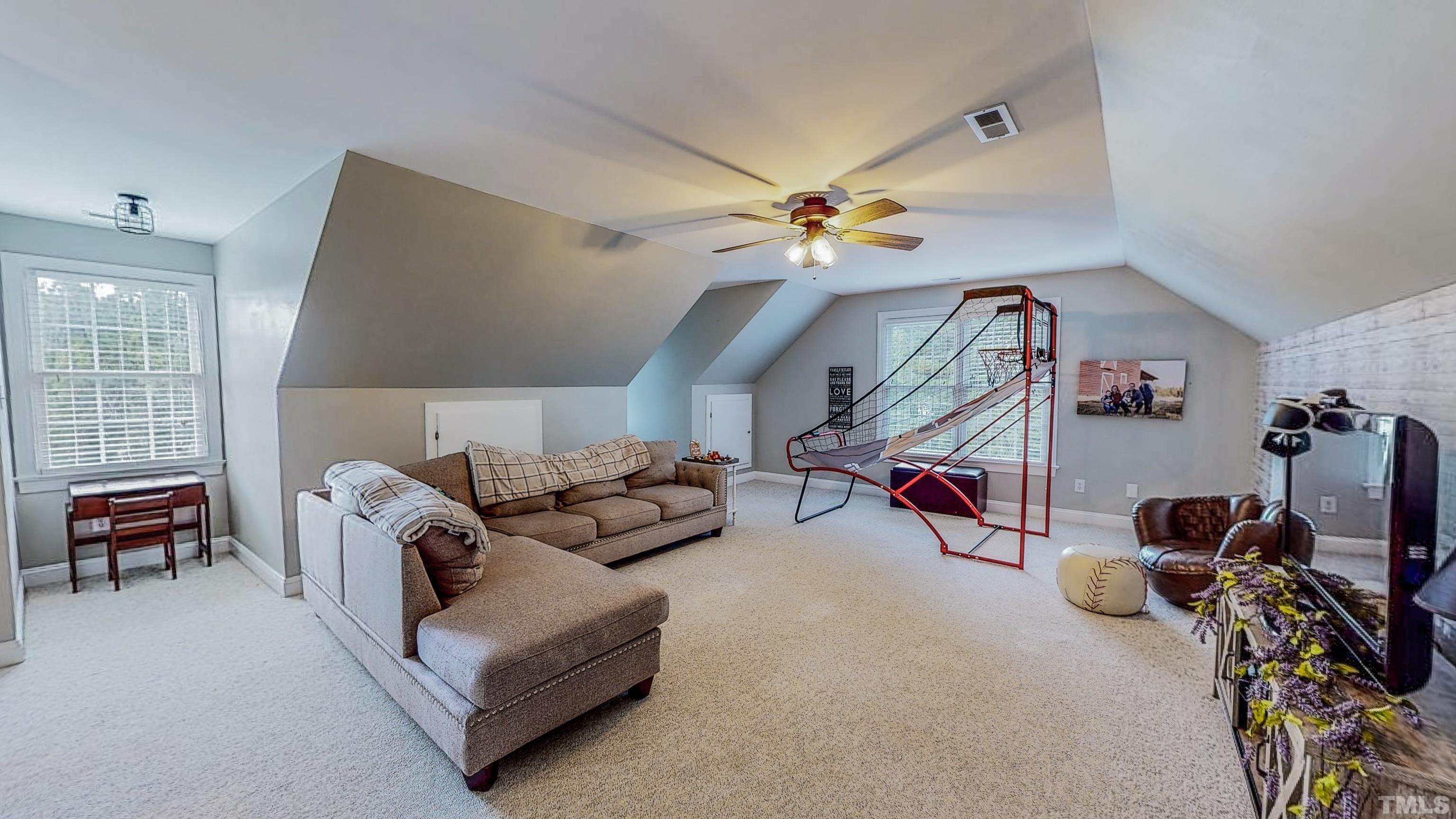 226 Fletcher Ridge Road Timberlake, NC 27583 - Photo 43 of 54 a living room with furniture a bike and a window