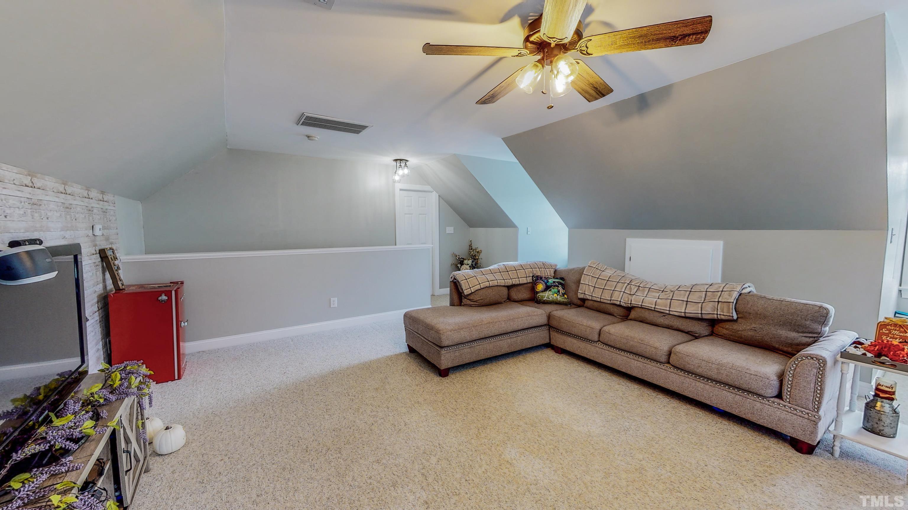226 Fletcher Ridge Road Timberlake, NC 27583 - Photo 44 of 54 a living room with furniture and a chandelier