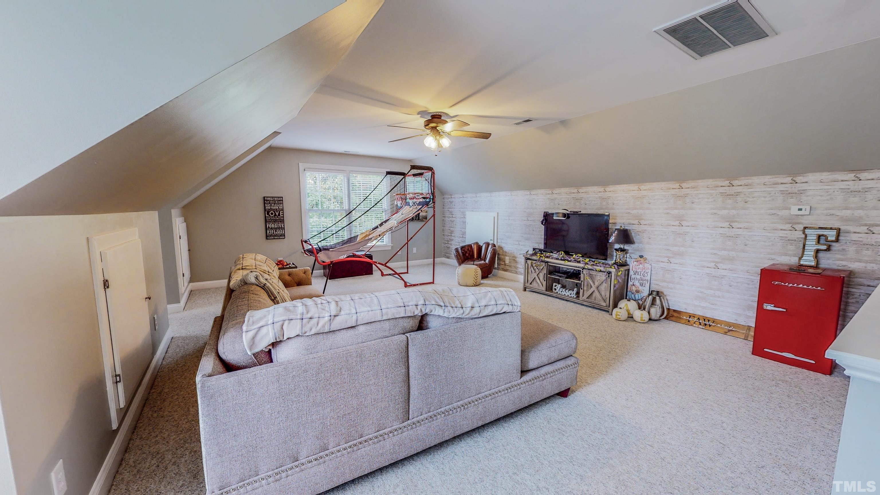226 Fletcher Ridge Road Timberlake, NC 27583 - Photo 45 of 54 a living room with furniture and a chandelier