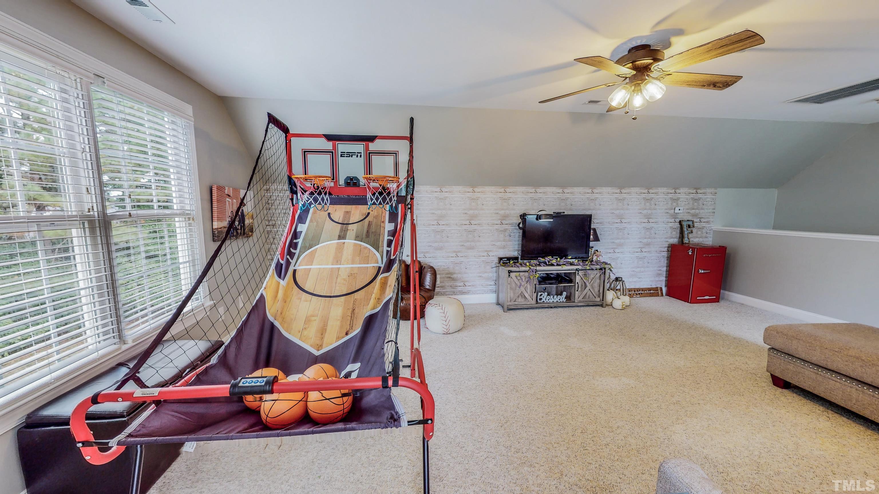 226 Fletcher Ridge Road Timberlake, NC 27583 - Photo 46 of 54 a living room with furniture a flat screen tv and a floor to ceiling window
