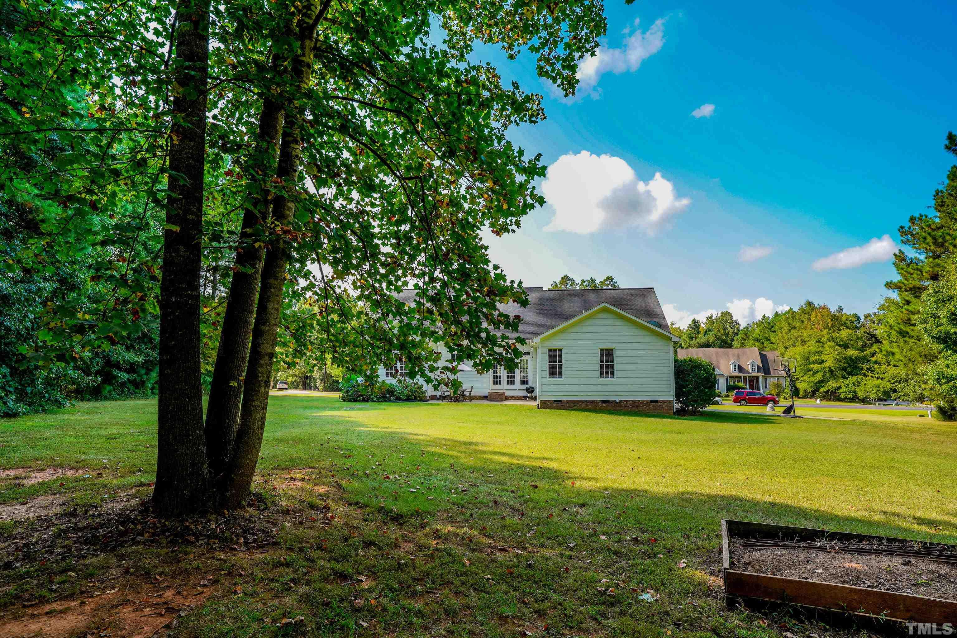 226 Fletcher Ridge Road Timberlake, NC 27583 - Photo 48 of 54 a view of a house with a big yard and large trees