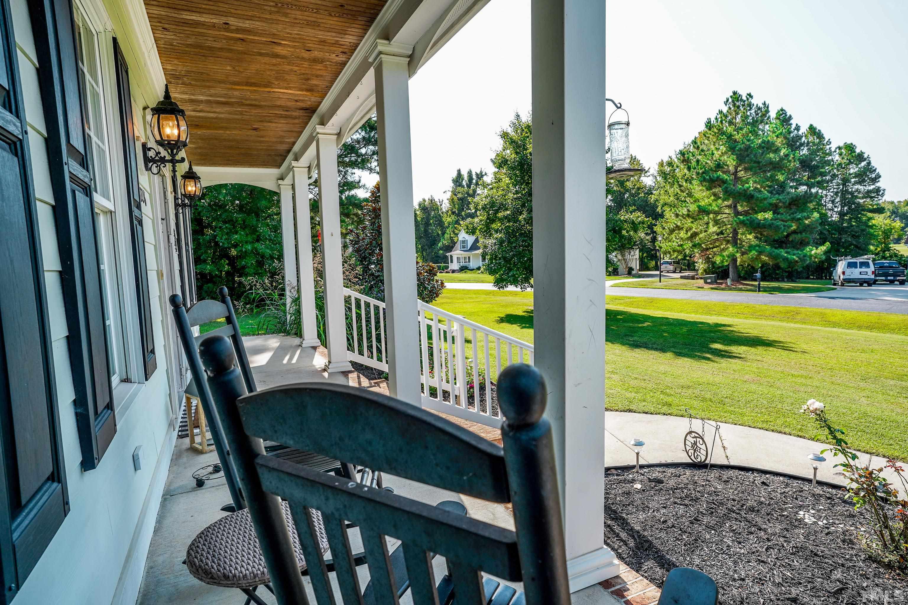 226 Fletcher Ridge Road Timberlake, NC 27583 - Photo 52 of 54 a view of a balcony with a table and chairs