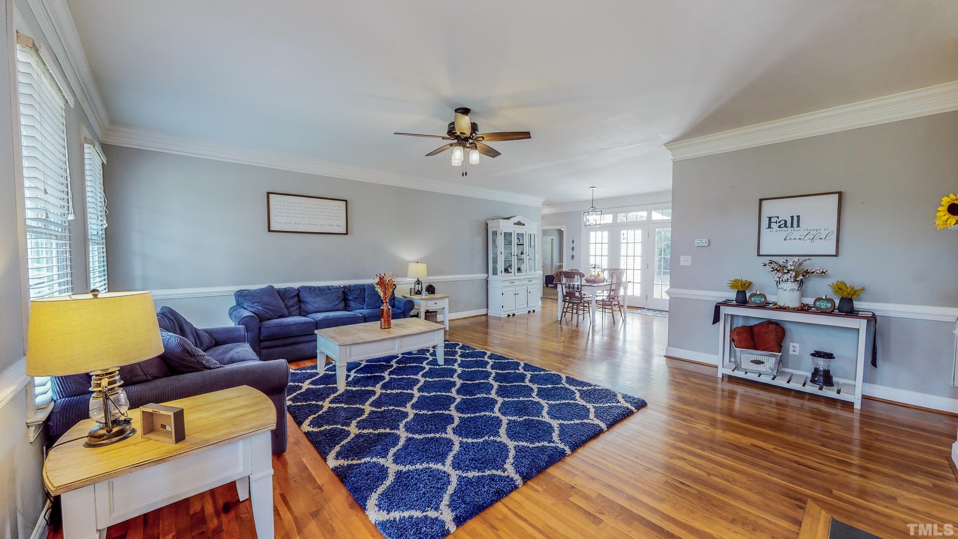 226 Fletcher Ridge Road Timberlake, NC 27583 - Photo 9 of 54 a living room with furniture a rug and a chandelier