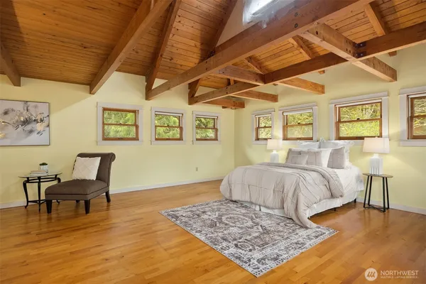 a spacious bedroom with a bed a table and chair