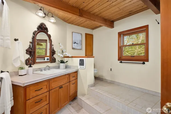 a white bath tub sitting next to a white wall