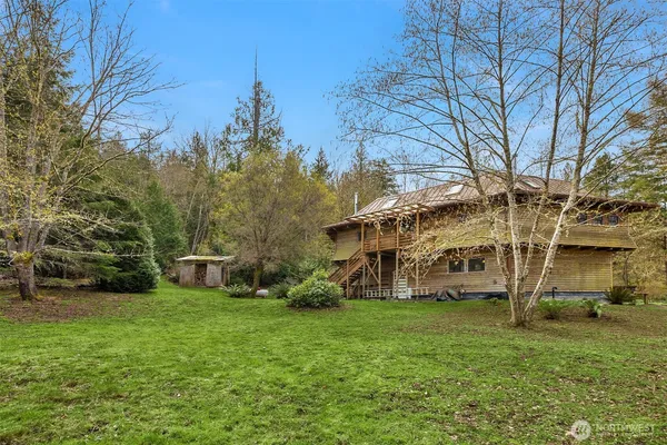 a view of a backyard with large trees