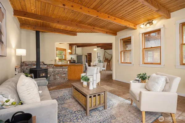 a living room with furniture a fireplace and wooden floor