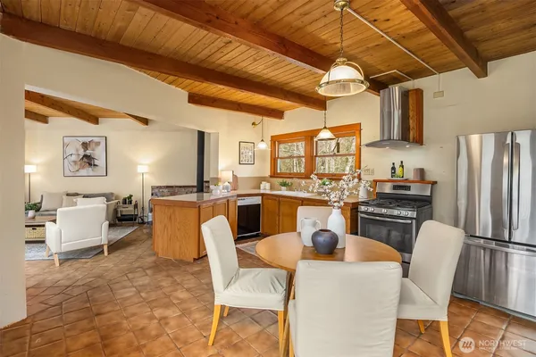 a dining room with furniture a kitchen view and a refrigerator