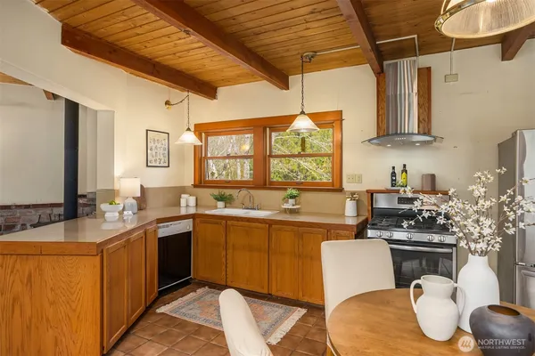 a kitchen with a sink stove and cabinets