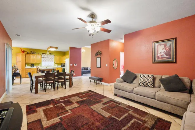 a living room with furniture a dining table and a piano