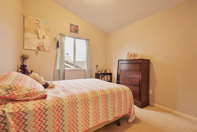 a bedroom with a bed and a dresser