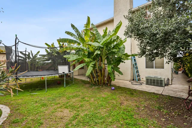 a backyard of a house with table and chairs
