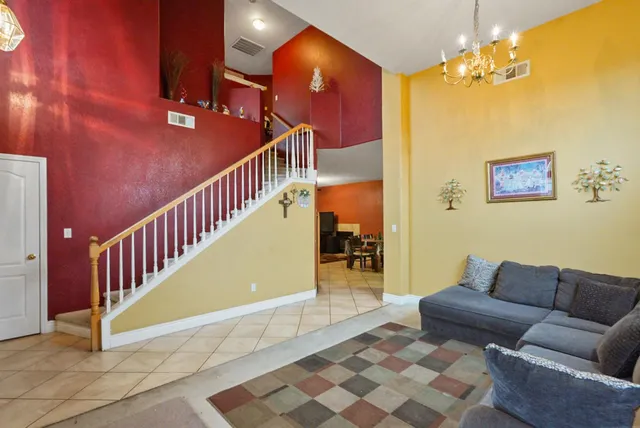 a living room with furniture and a chandelier