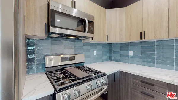 a kitchen with a stove and microwave