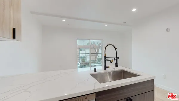 a kitchen with a sink and a large window