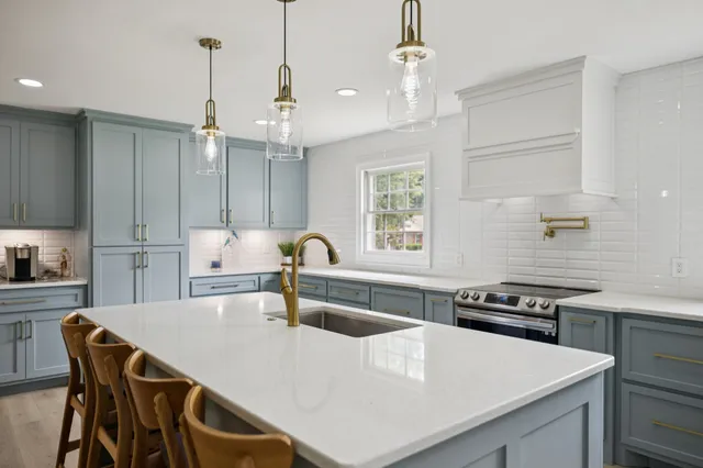 a kitchen with stainless steel appliances granite countertop a stove a sink dishwasher and a refrigerator