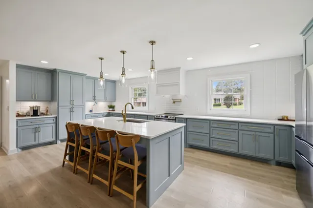 a kitchen filled counter top space and wooden floor