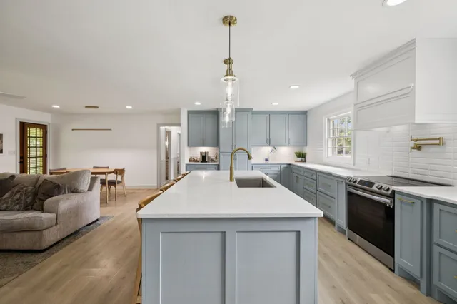 a spacious bathroom with a granite countertop sink mirror and shower