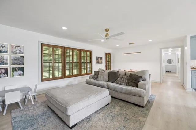 a living room with furniture and a mirror
