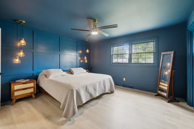 a bedroom with furniture and a window