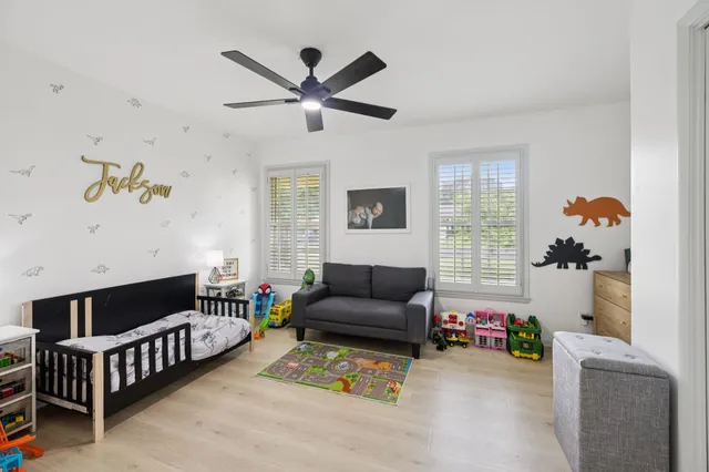 front view of a house with a yard and an trees