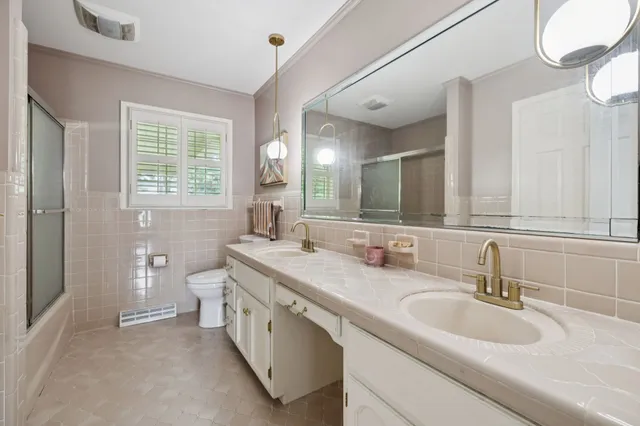 an aerial view of a house with a garden and swimming pool