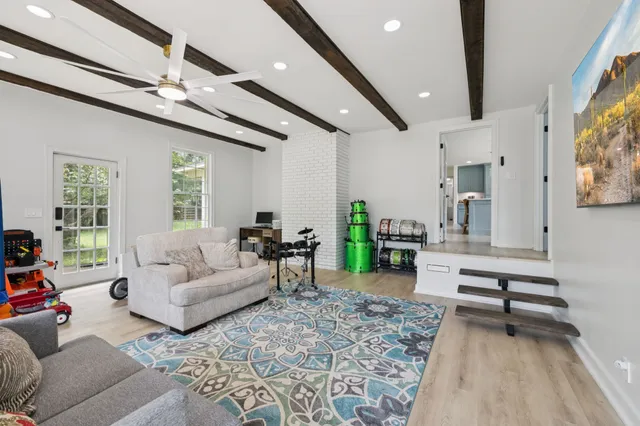 an aerial view of residential houses with outdoor space and trees