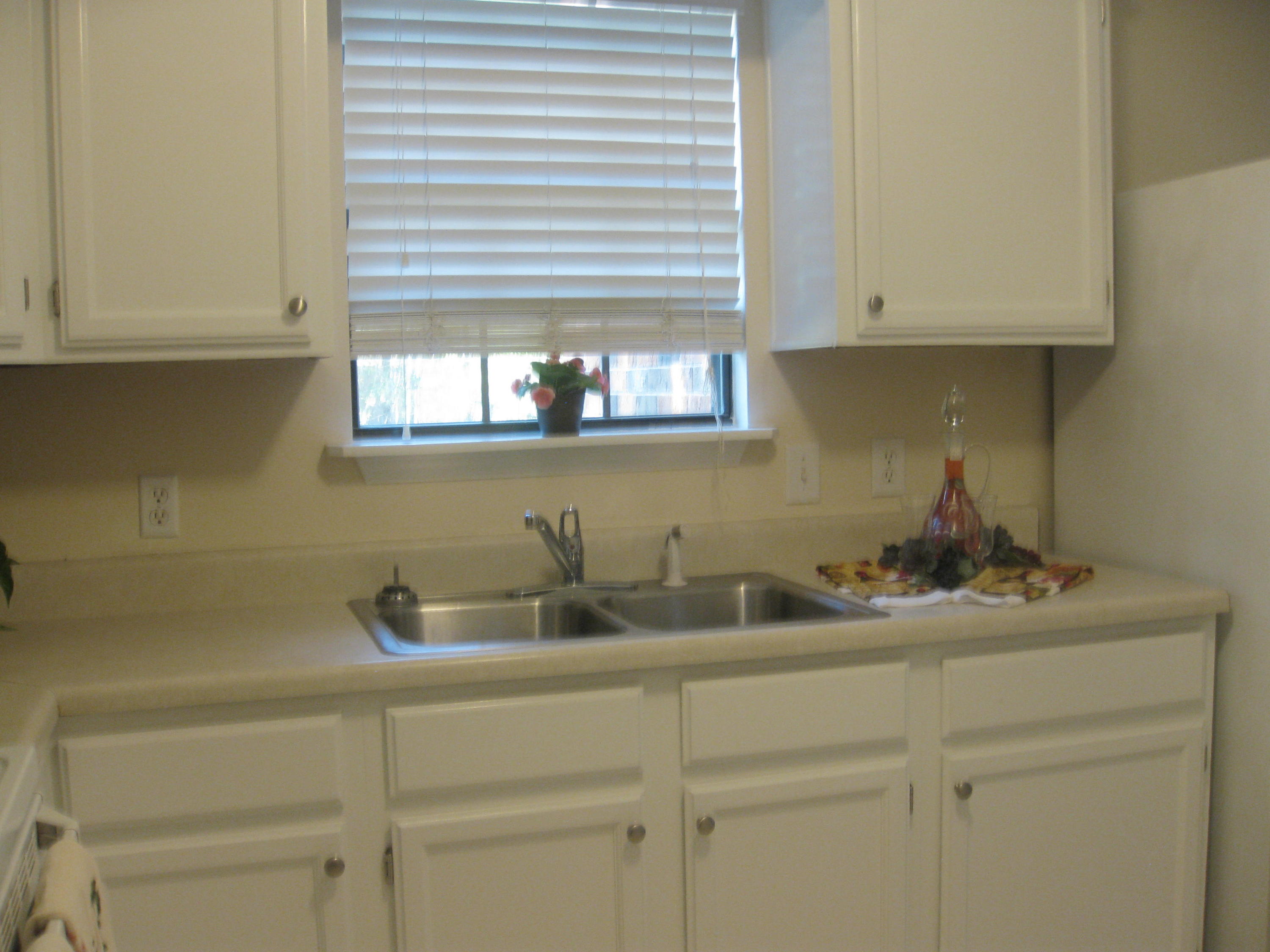 3310 Auburn Road Crestview, FL 32539 - Photo 25 of 44 a kitchen with a sink and cabinets