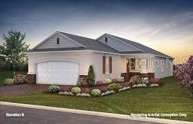 a front view of a house with a garden and yard