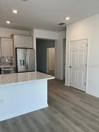 a view of a kitchen with wooden floor